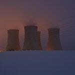 a group of cooling towers in the snow