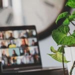 black flat screen tv turned on near green plant